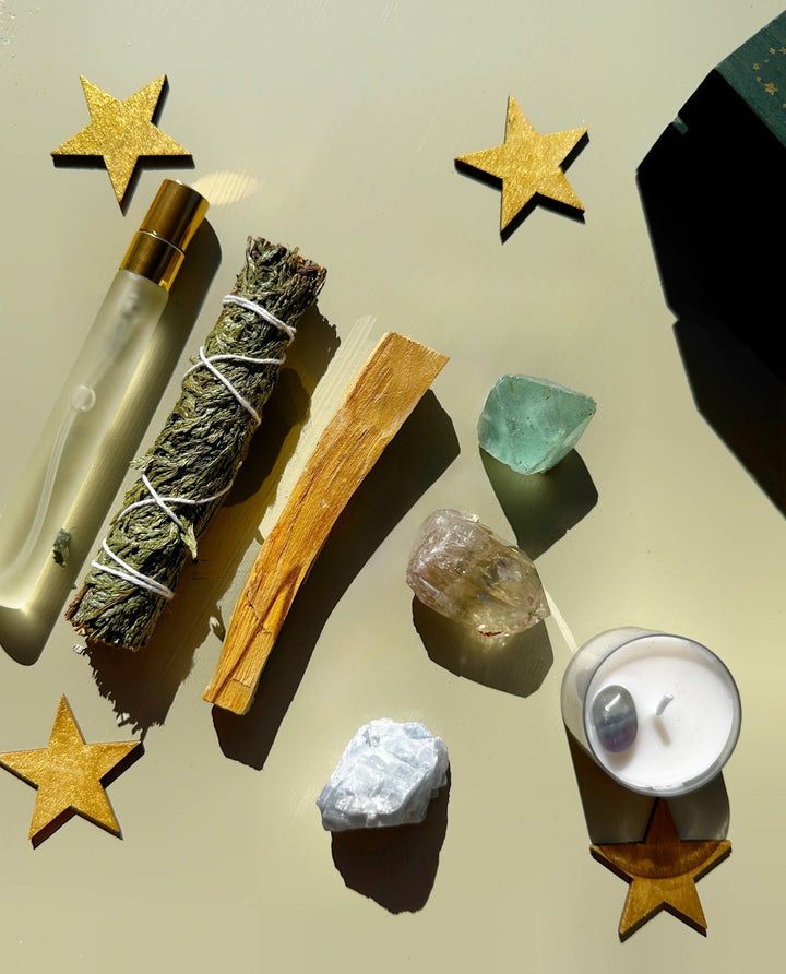 Reset and protect your energy with this crystal and smudge kit—sage, palo santo, spray, and stones for grounding and balance.