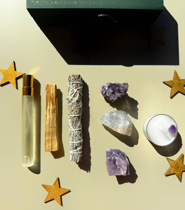 Reset and protect your energy with this crystal and smudge kit—sage, palo santo, spray, and stones for grounding and balance.